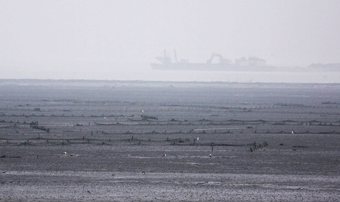 Mudflat with enclosing wall under construction